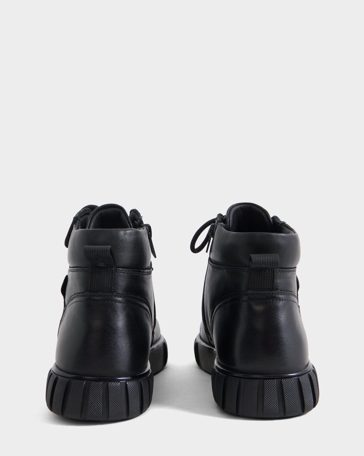 Back view of DAVE - 6226501 Black leather high-top boots with thick, ridged rubber soles.