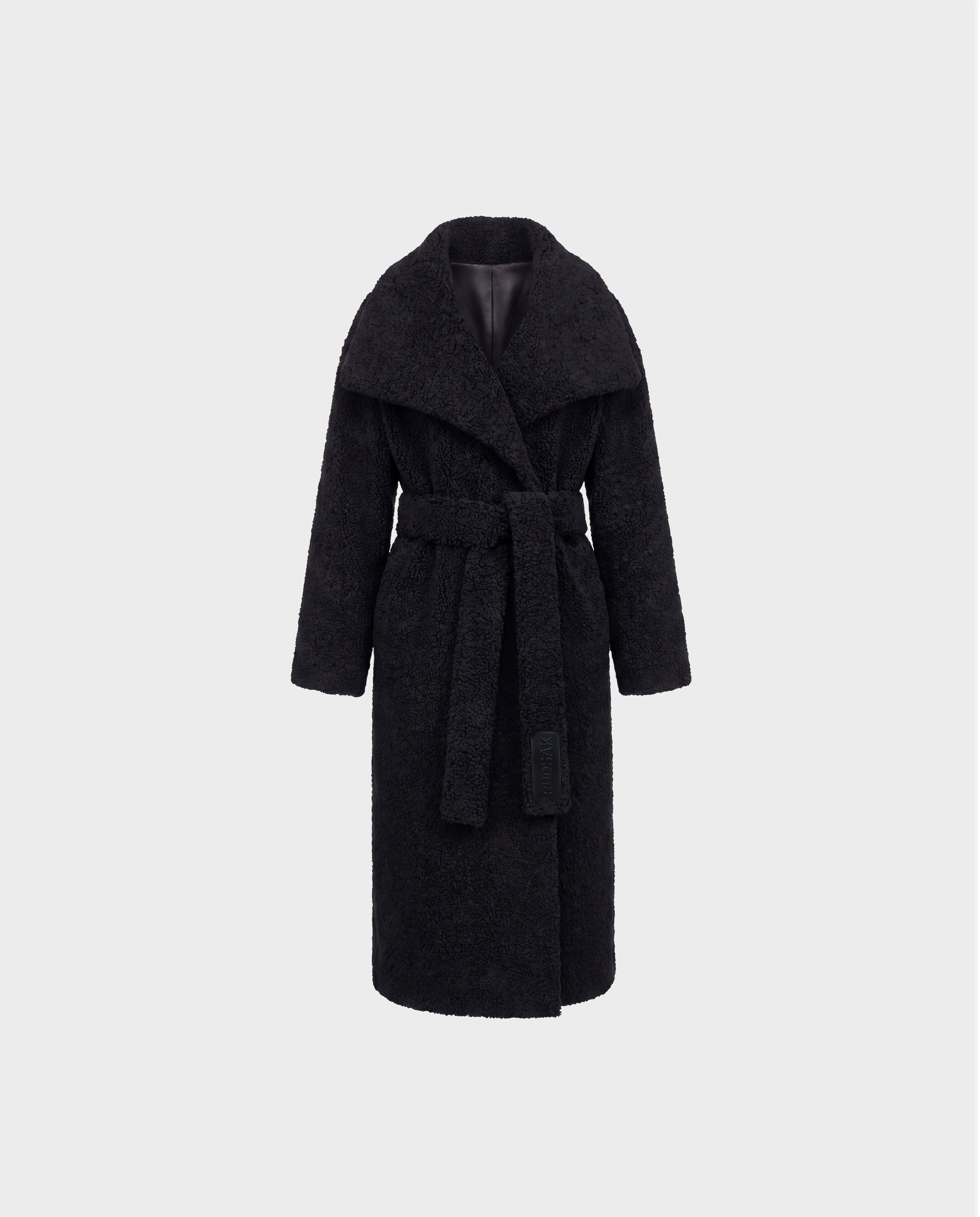 The FRANCIE - 8126873 Black coat by Rudsak is a long black belted design featuring a wide collar and textured plush faux shearling fabric, shown against a plain light gray background.