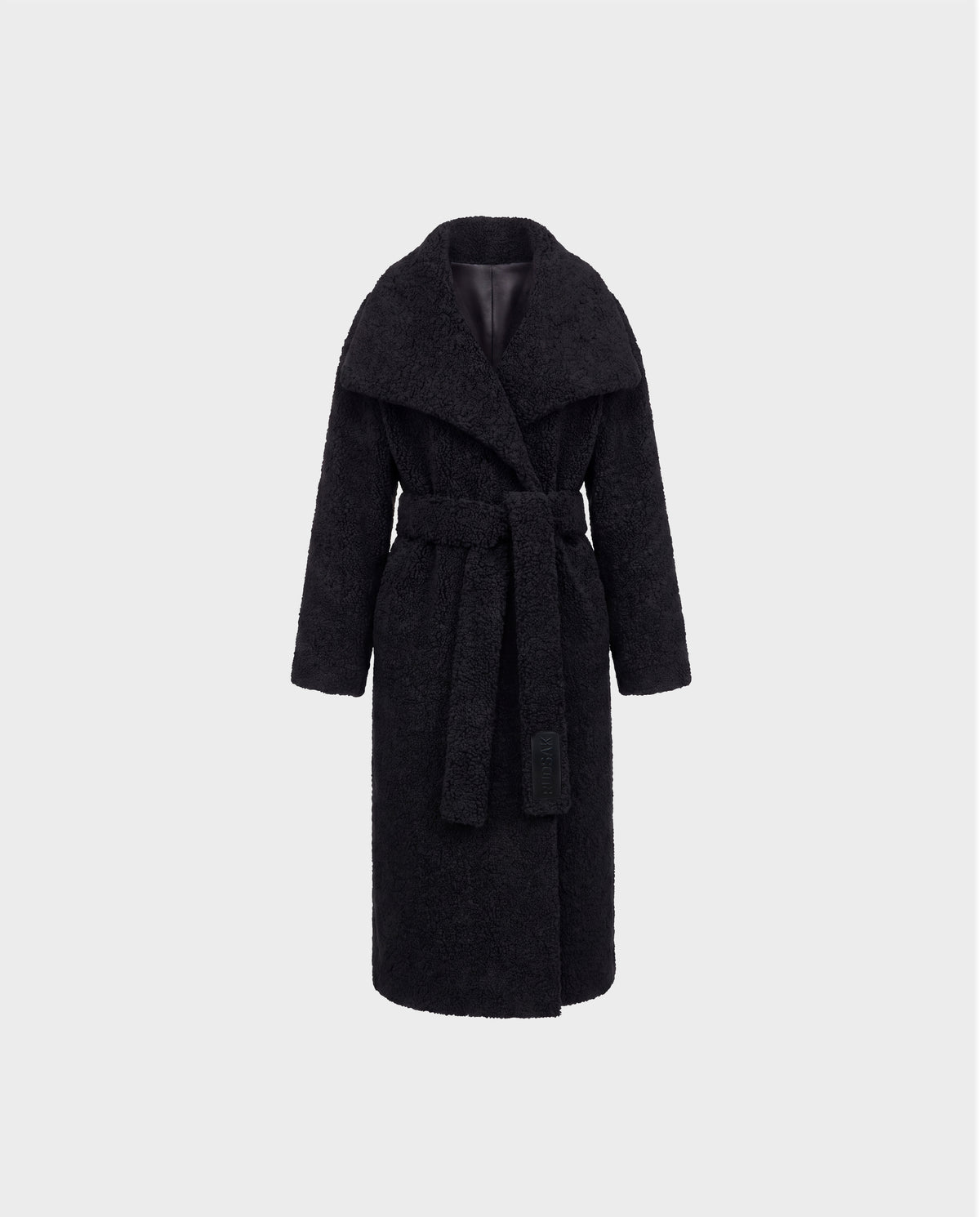 The FRANCIE - 8126873 Black coat by Rudsak is a long black belted design featuring a wide collar and textured plush faux shearling fabric, shown against a plain light gray background.