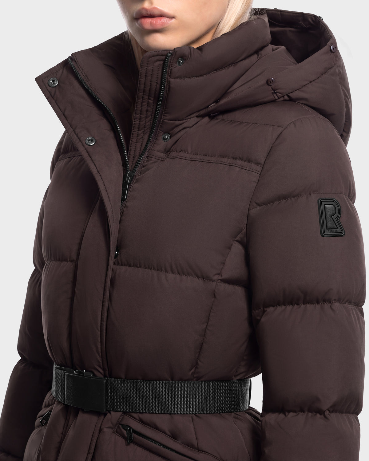 A dark brown Rudsak GRACE FF - 8126535 Espresso hooded goose down puffer jacket featuring a black waist belt and a rectangular logo patch on the sleeve.