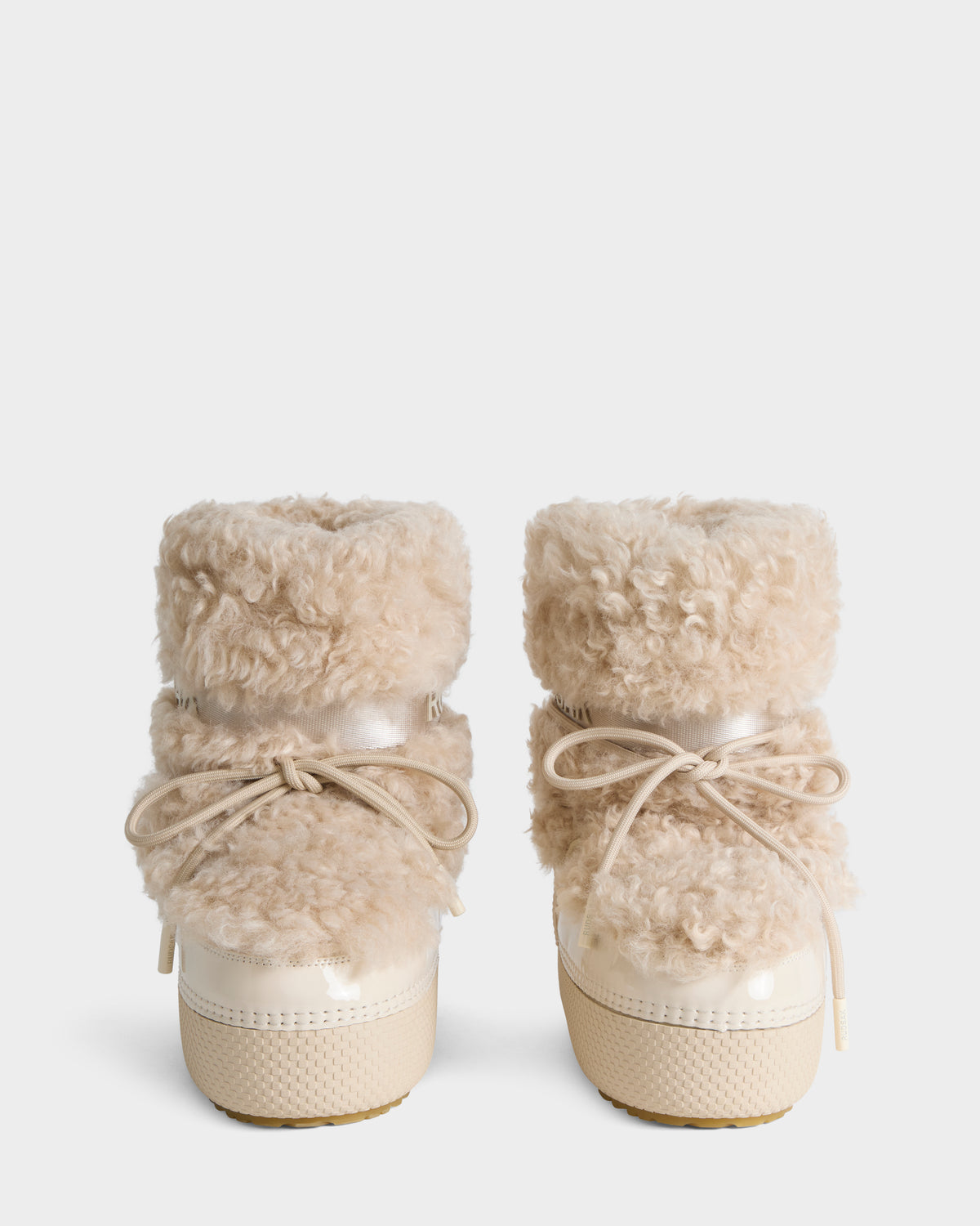 KATHY Y - 1224500 Vanilla cream-colored ankle boots featuring fluffy shearling cuffs, lace-up fronts, and thick platform soles.