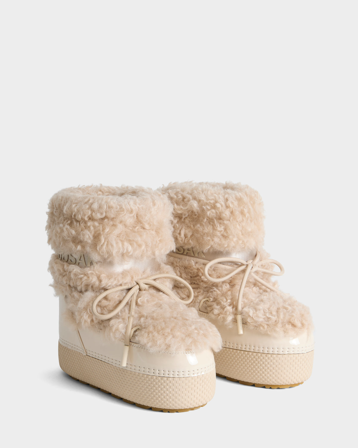 KATHY Y - 1224500 Vanilla pair of cream-colored insulated platform winter boots with fluffy fleece cuffs and lace-up closures.