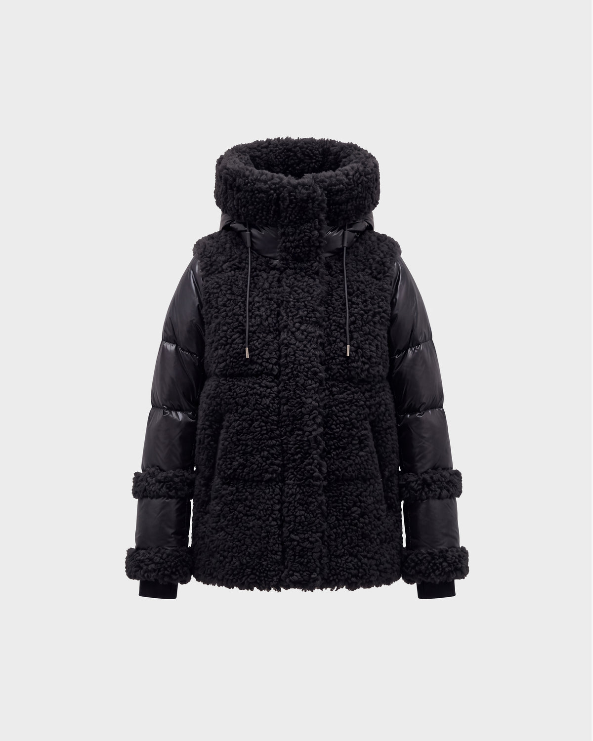The MARISSA - 8126728 Black by Rudsak is a stylish winter jacket featuring a high, padded collar, shearling-textured body, and smooth quilted sleeves. This sherpa coat includes drawstrings at the collar and boasts chunky, textured details on both the body and sleeves—making it an ideal piece of winter outerwear.
