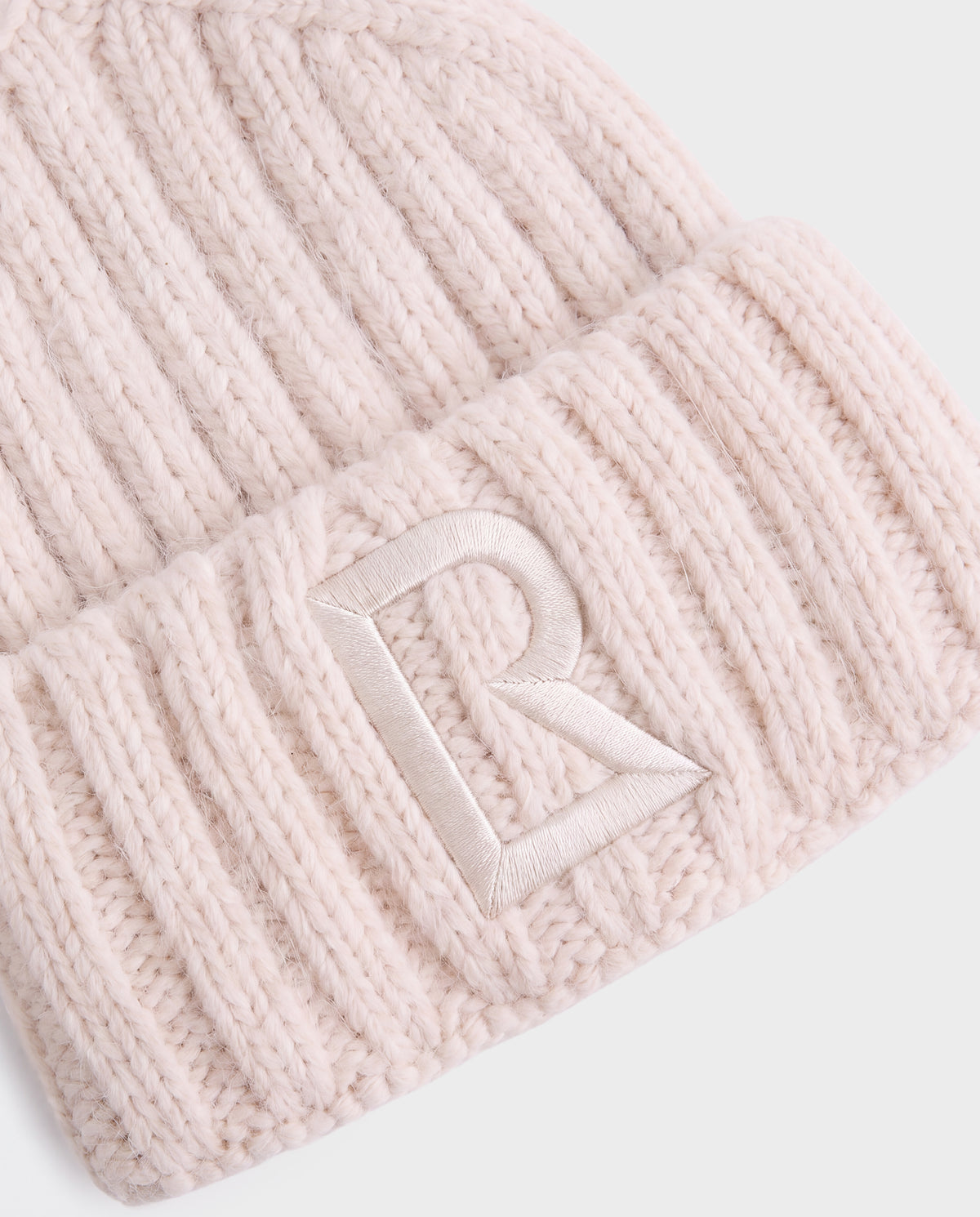 Cream-colored MISSA - 8426512 Vanilla ribbed knit beanie with an embroidered letter R on the fold.