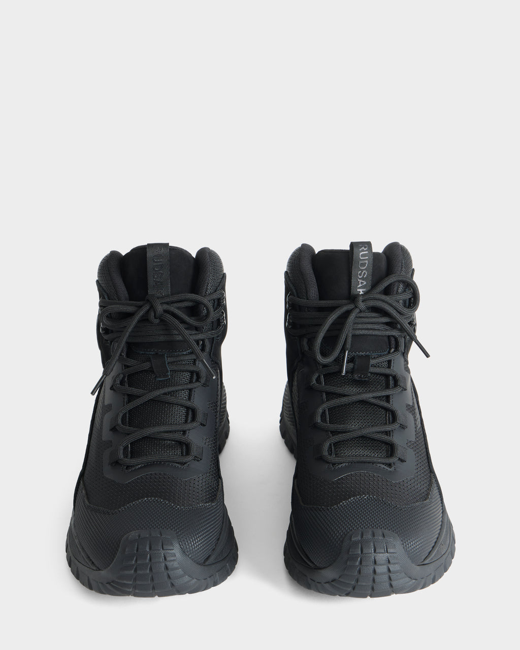 A pair of Rudsak REXON - 6226503 black high-top sneakers with thick soles, seen from above and facing forward, on a plain white background.