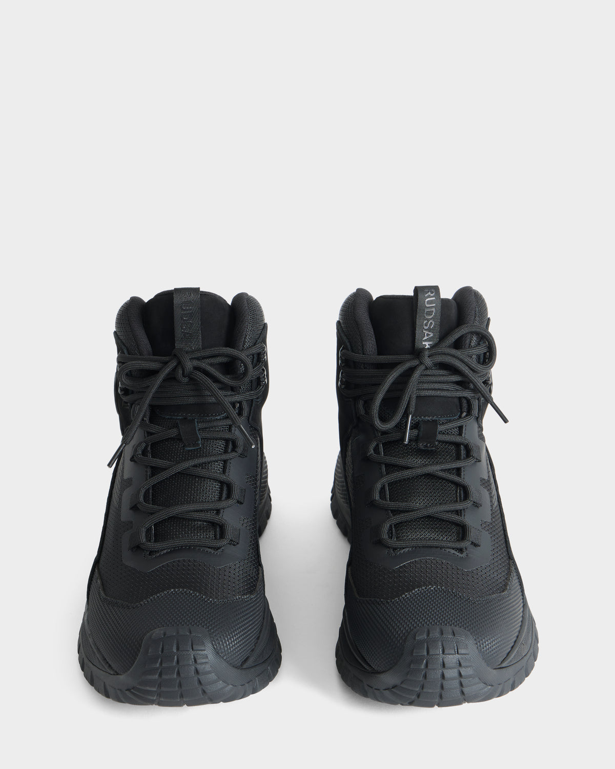 A pair of Rudsak REXON - 6226503 black high-top sneakers with thick soles, seen from above and facing forward, on a plain white background.