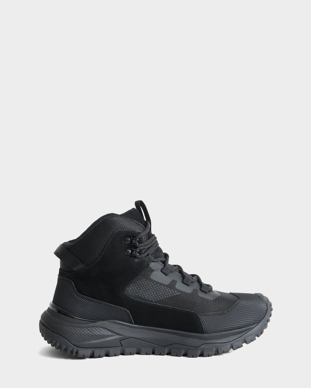 The REXON - 6226503 Black by Rudsak is a black, winter-ready high-top hiking boot featuring a textured sole, lace-up front, and mesh and suede panels, shown in profile against a plain light gray background.