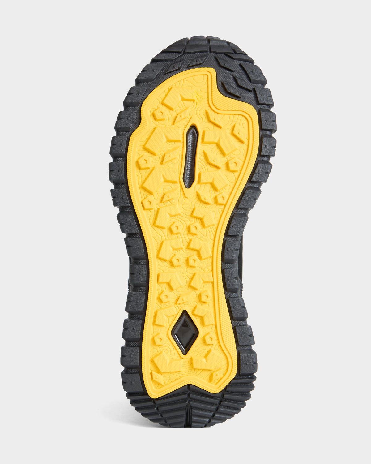 The image shows the sole of the Rudsak REXON - 6226503 Black boot, featuring a rugged black and yellow tread pattern designed for traction on winter terrain.