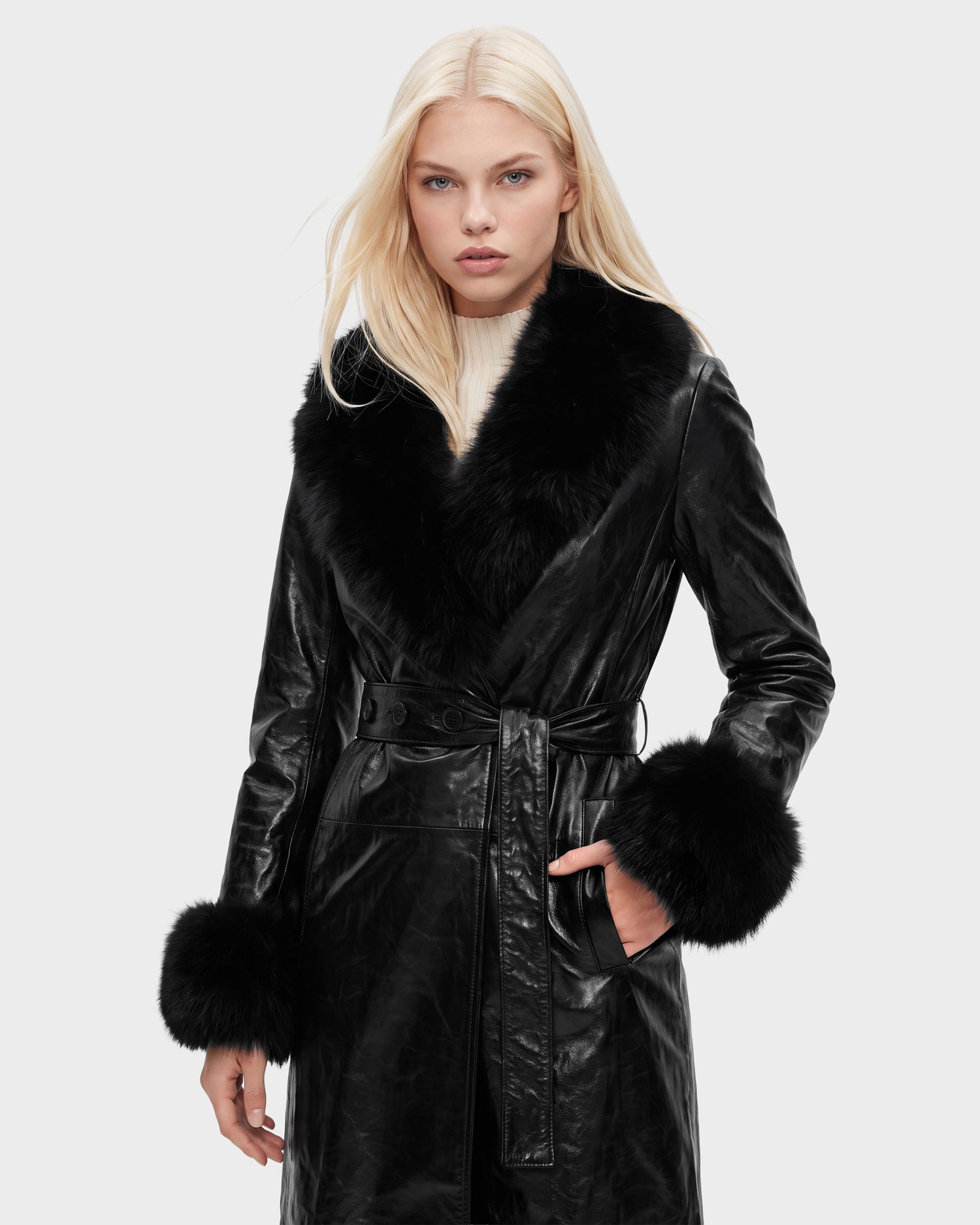A woman with straight blonde hair models the Rudsak VIVIANNE - 8126933 Black leather coat, featuring a wide fur collar and fur cuffs, against a plain light background. Available for pre-order now, with expected delivery by August 17, 2026.