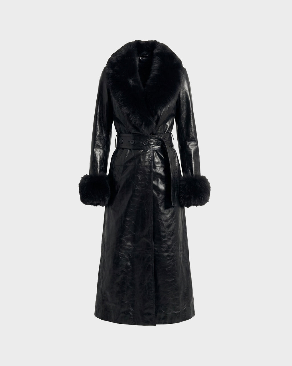 The VIVIANNE - 8126933 Black by Rudsak is a long black leather trench coat with a luxurious faux fur collar and large fur-trimmed cuffs, featuring a matching leather belt at the waist, displayed on a plain light background.