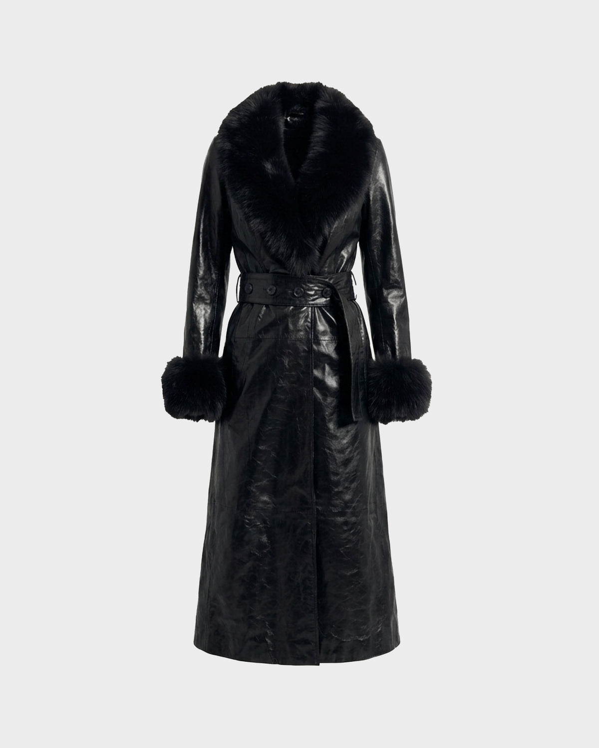 The VIVIANNE - 8126933 Black by Rudsak is a long black leather trench coat with a luxurious faux fur collar and large fur-trimmed cuffs, featuring a matching leather belt at the waist, displayed on a plain light background.