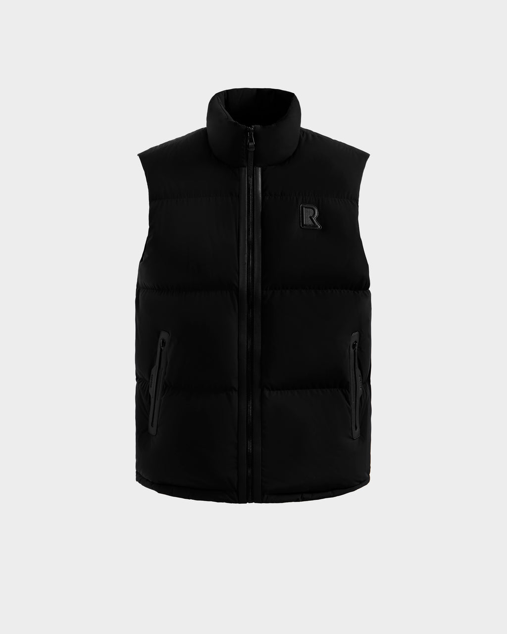 The FREDDY - 6125571 Black men’s puffer vest by Rudsak features a high collar, front zipper, two zippered pockets, and a subtle R logo on the left chest. Ideal for lightweight layering, it's shown against a plain light gray background.