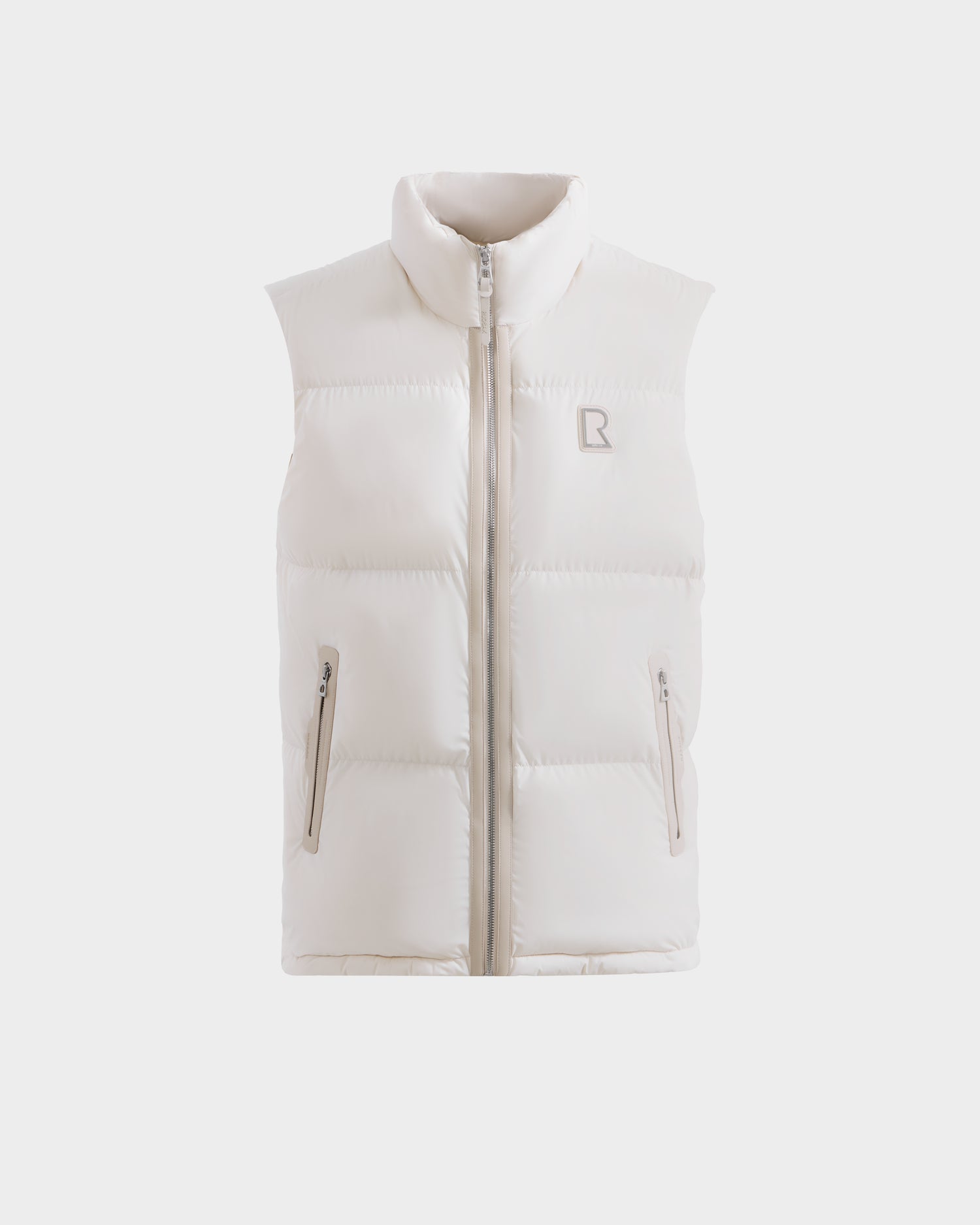 The FREDDY - 6125571 Vanilla by Rudsak is a sleeveless white men's puffer vest with a high collar, front zipper, two zippered side pockets, and a subtle stitched chest logo—perfect for lightweight layering.