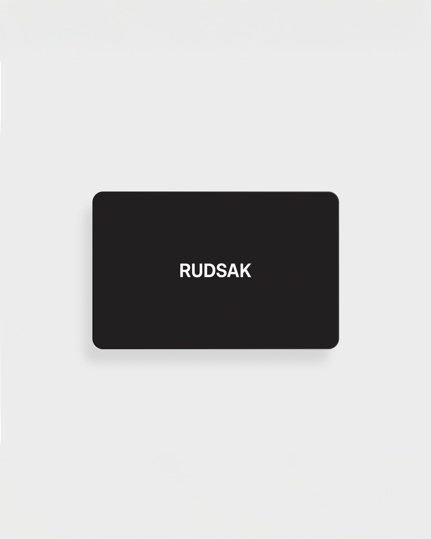 A black rectangular Rudsak VIRTUAL GIFT CARD - English with "RUDSAK" in white, centered on a plain white background—an online gift card with no expiration and easy email delivery.
