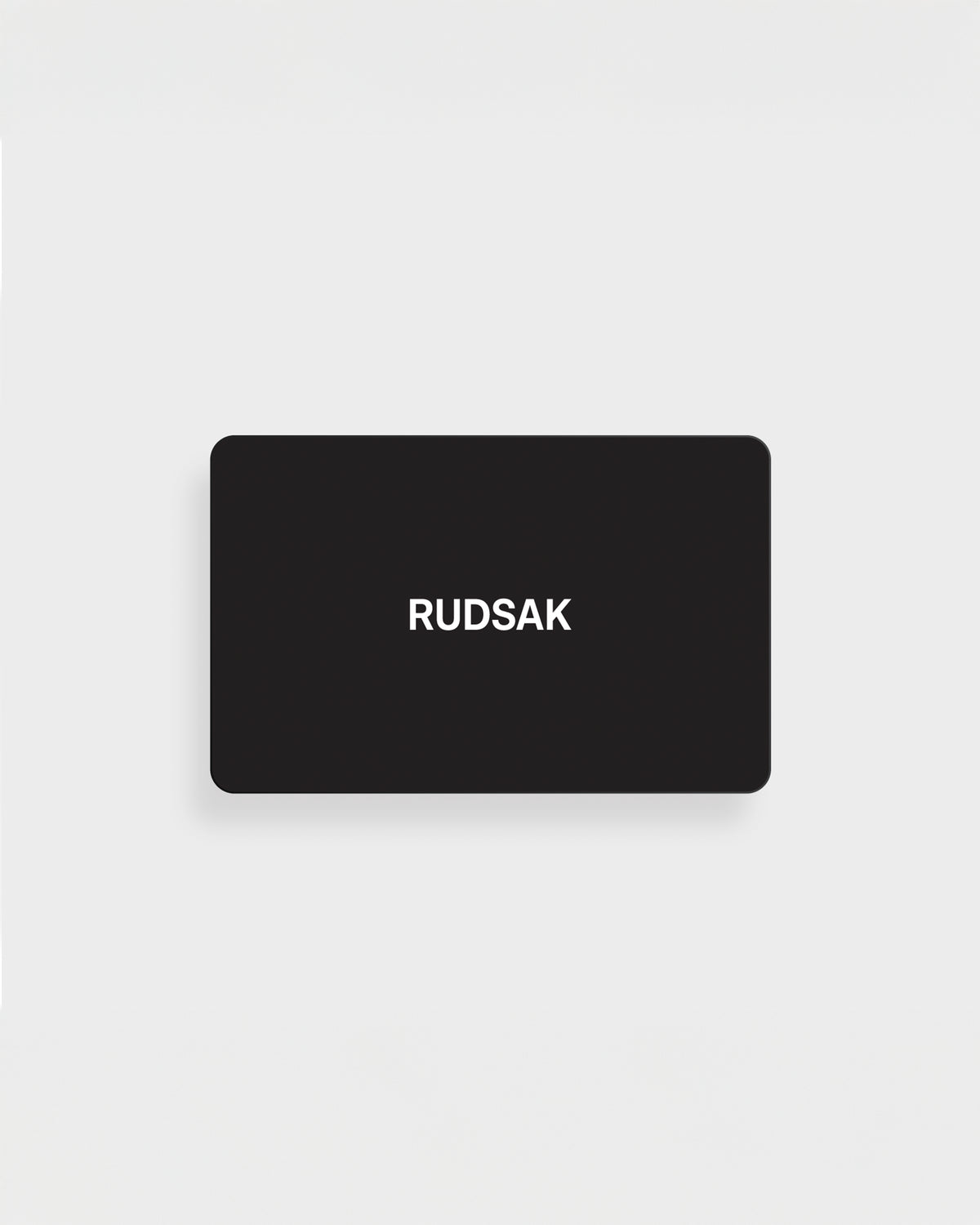 A black rectangular Rudsak VIRTUAL GIFT CARD - English with "RUDSAK" in white, centered on a plain white background—an online gift card with no expiration and easy email delivery.