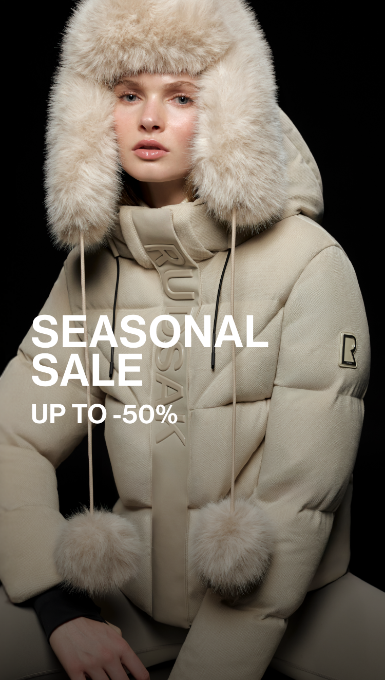 Person wearing a beige winter coat with fur trim, sitting against a black background, with 'SEASONAL SALE' text overlay.