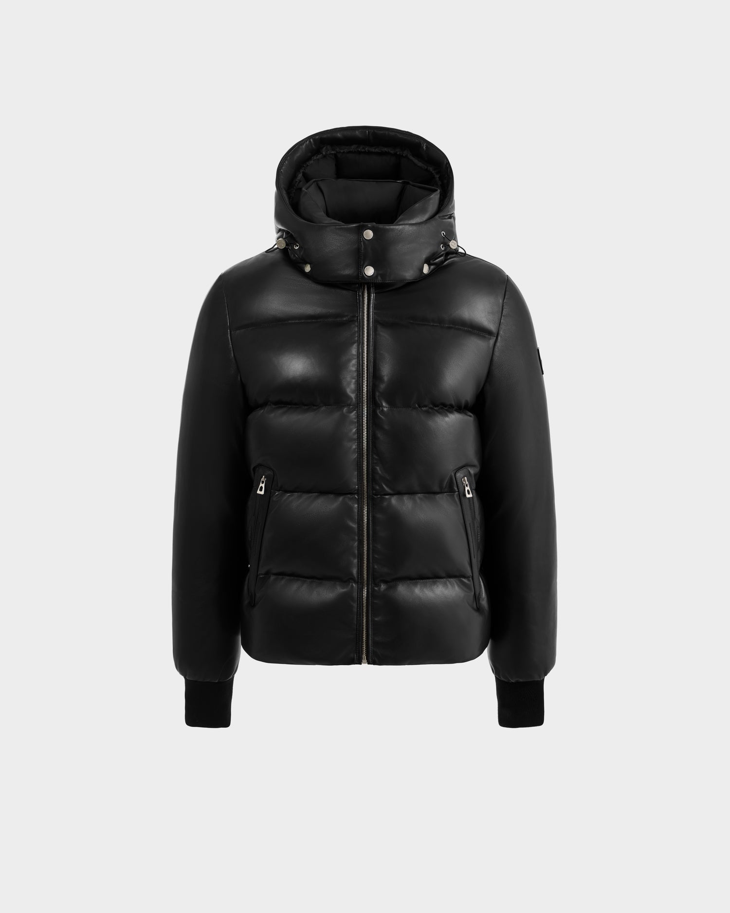 The HARVEY X - 6125681 Black puffer jacket by Rudsak features black leather, a hood, front zipper, snap collar buttons, ribbed cuffs, and two zippered side pockets. Shown against a plain light gray background.
