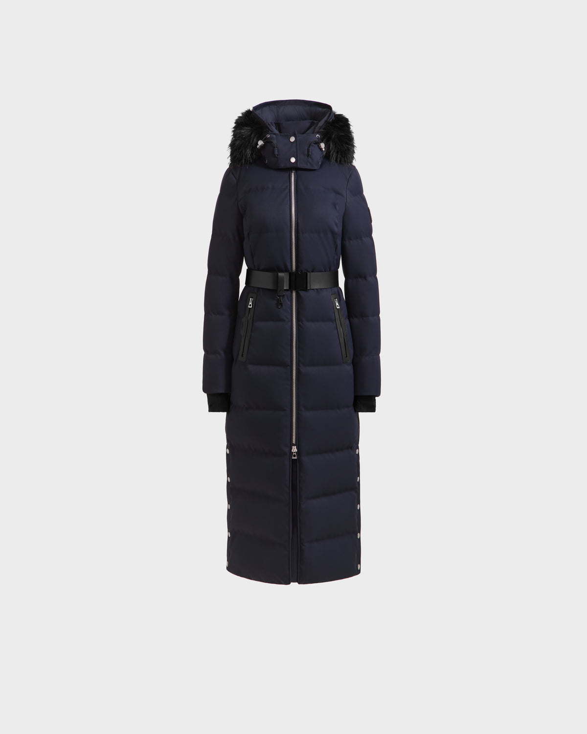 The Rudsak IZABELLA H - 8125644 Navy women’s puffer, featuring a black faux fur–trimmed hood, belted waist, zip front, and side pockets, is shown on a plain white background.