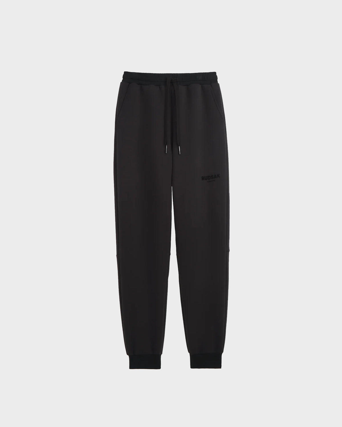 The JOSS - 9524009 Black W joggers by Rudsak are crafted from premium cotton, featuring an elastic waistband, drawstring, side pockets, and elastic cuffs—offering a comfortable and stylish unisex option in sleek black.