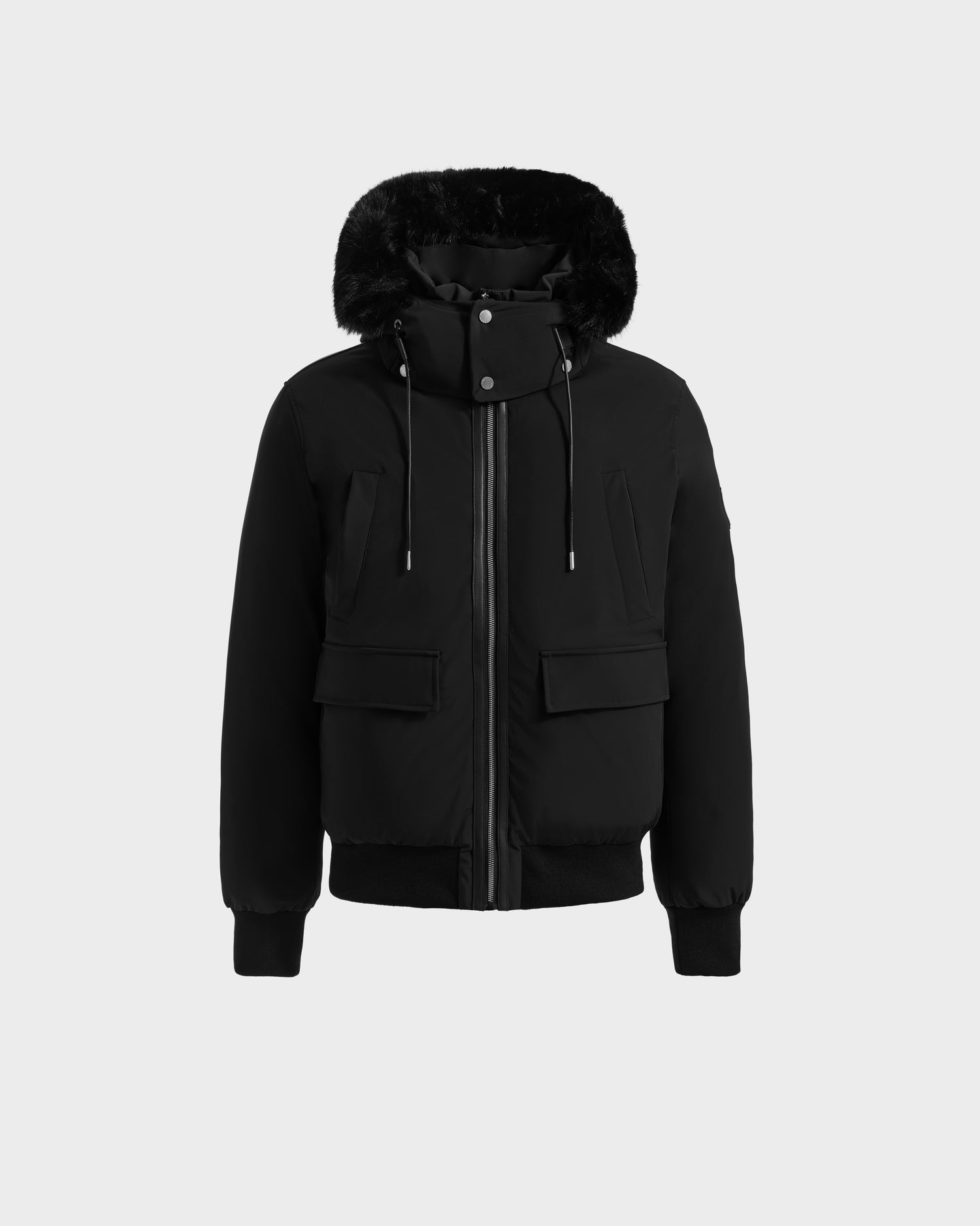 The Rudsak JEROME - 6125514 Black men’s down bomber features a fur-lined hood, front zipper, two flap pockets, ribbed cuffs and hem, and a high snap-button collar—your ideal winter performance jacket.