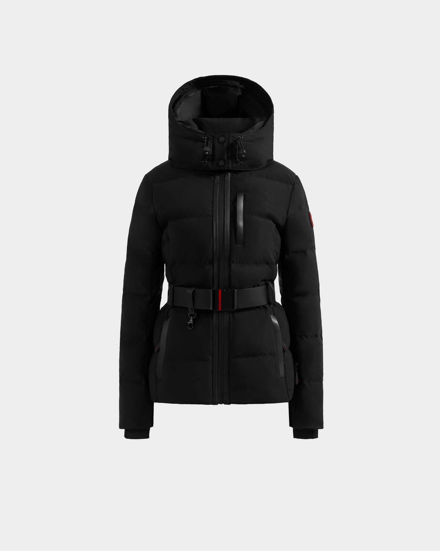 The Rudsak JOANNA - 8124788 Black is a belted, hooded puffer jacket with front zipper, chest and side pockets, and high neckline, shown on a light gray background. Pre-order now; ships by November 30th.