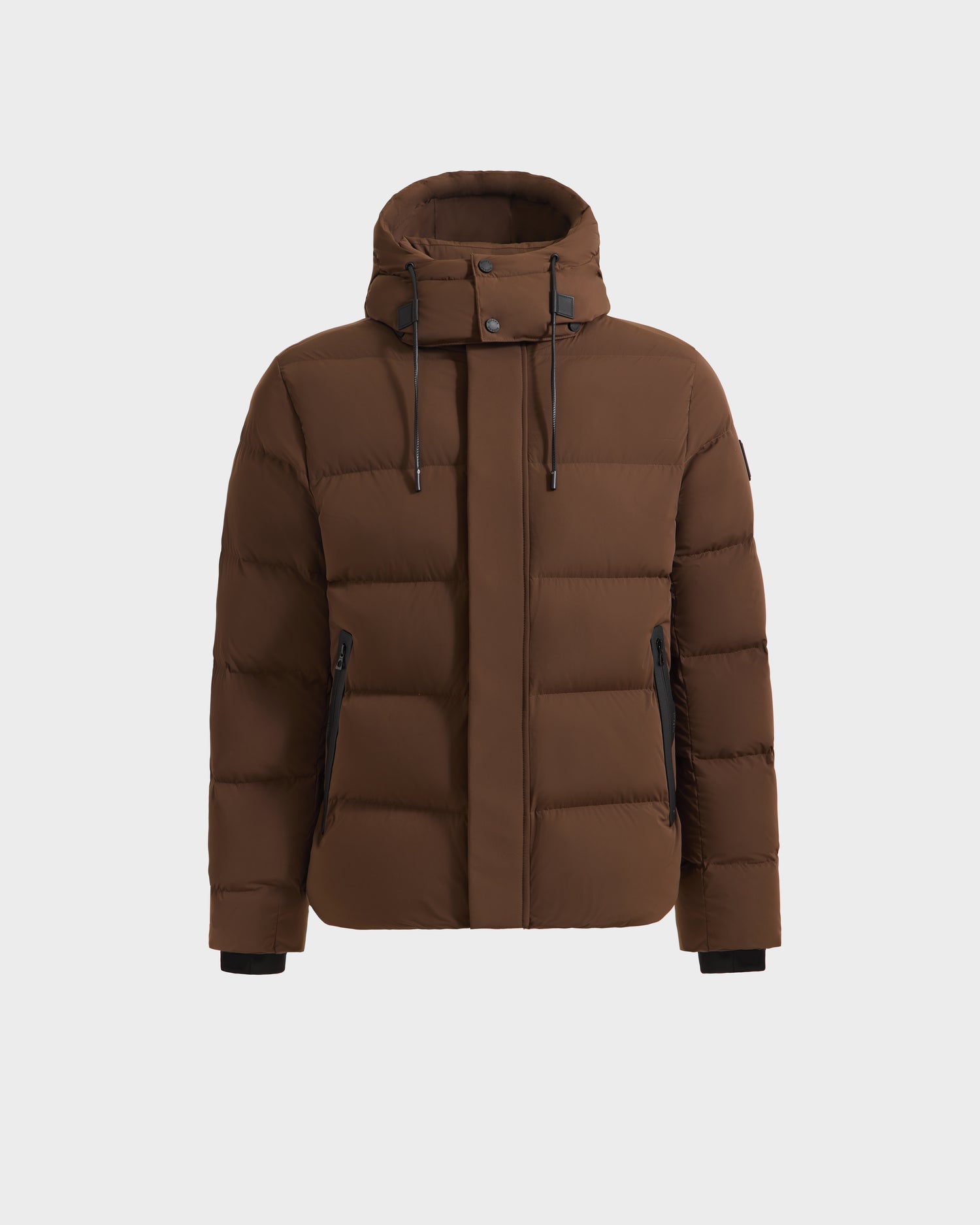 The Rudsak JOEL - 6124605 Mocha men’s puffer jacket features a hood, front zipper, snap buttons, two zippered side pockets with black accents, and a weather-resistant shell for dependable cold-weather protection.