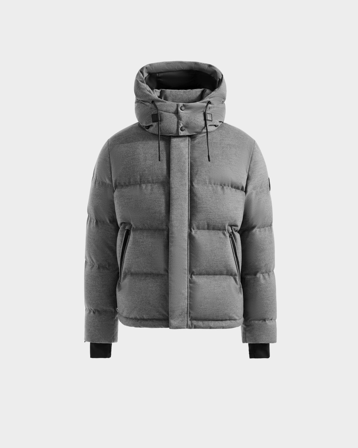 The JOEL W - 6125683 Heather Charcoal by Rudsak is a men’s gray wool-blend down puffer jacket with a removable hood, front zipper and snap buttons, angled front pockets, and black ribbed cuffs, shown on a plain light background.