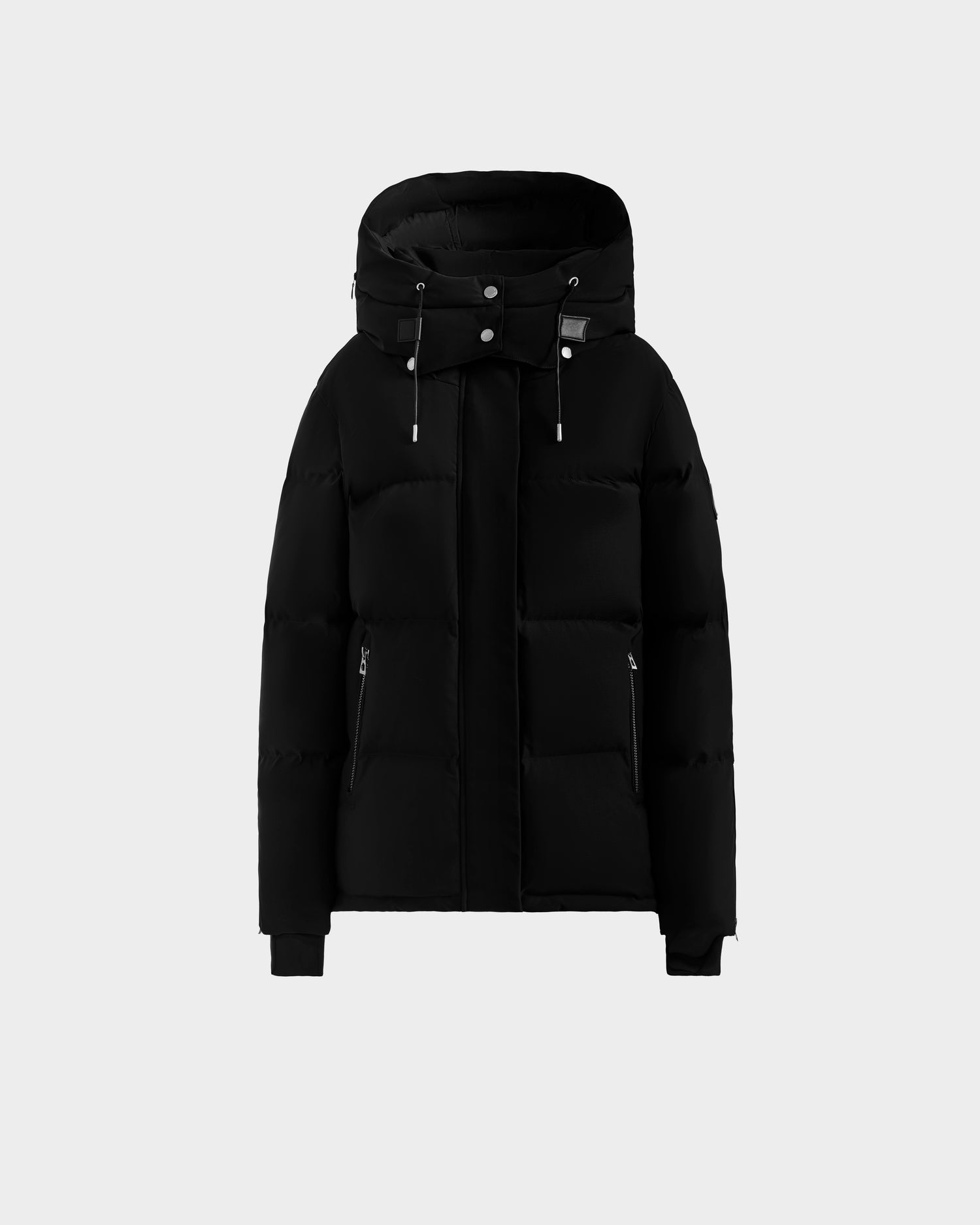 The Rudsak JOON H - 8125586 Black is a women’s down jacket with a hood, front zipper, two zippered pockets, and ribbed cuffs, made with RDS-certified down and shown against a light gray background.