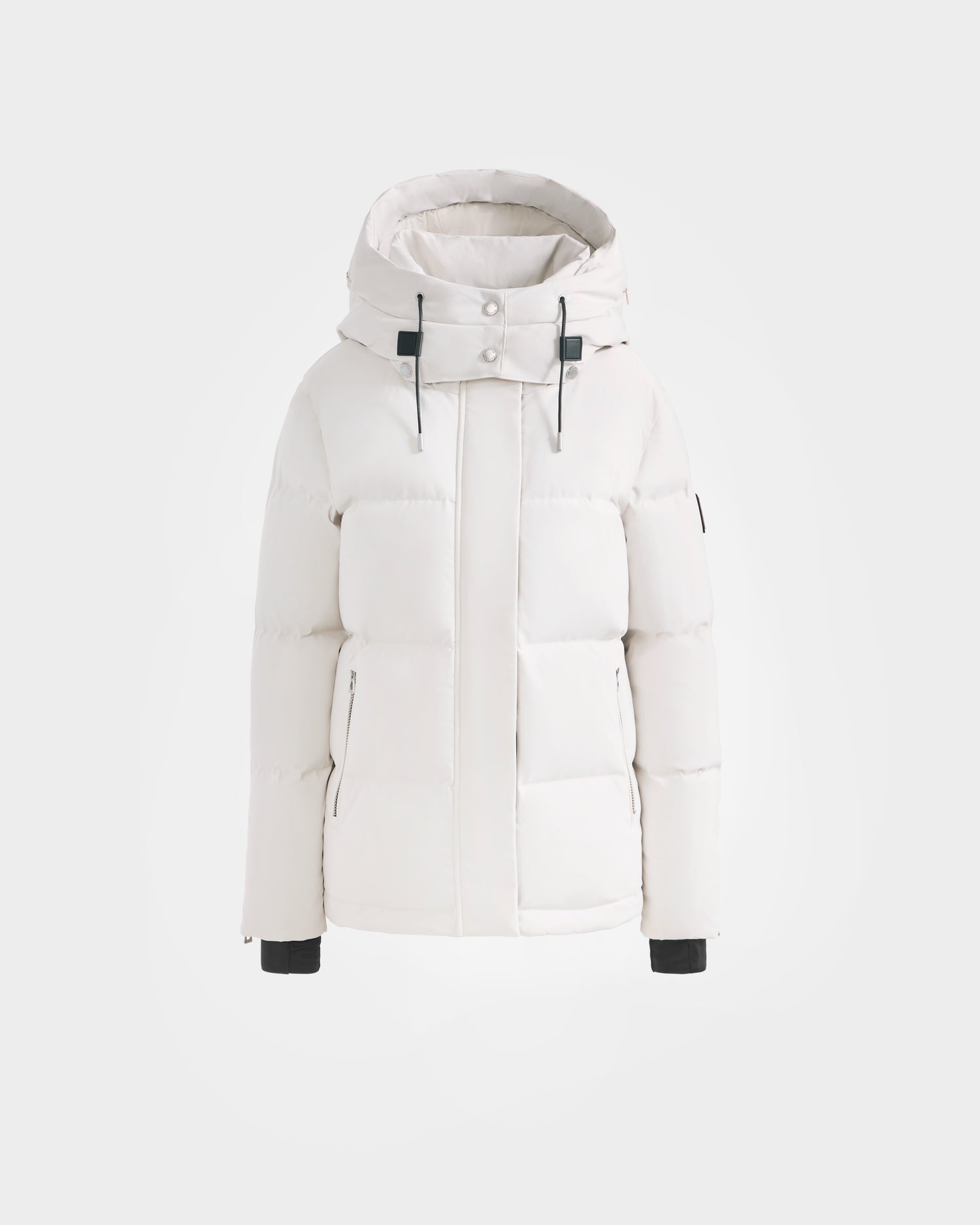 The Rudsak JOON H - 8125586 Vanilla is a white women's down jacket with a hood, front zipper, snap buttons, black drawstrings, quilted design, high collar, long sleeves with black cuffs, and a modern look.