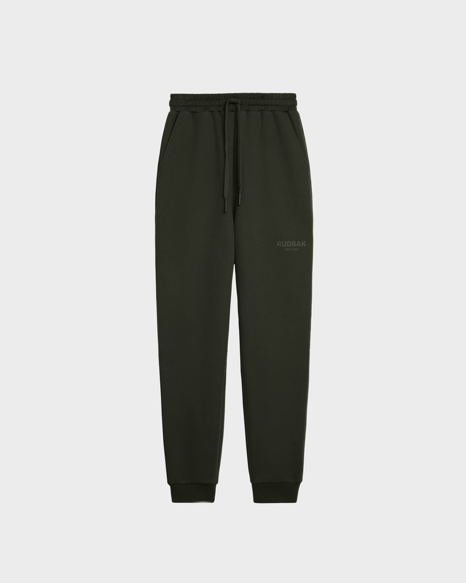 The Rudsak JOSS - 9524009 Dark Olive M joggers feature premium cotton, an elastic waistband with drawstring, side pockets, and ribbed cuffs—perfect unisex pants for everyday style and comfort. Displayed on a plain white background.
