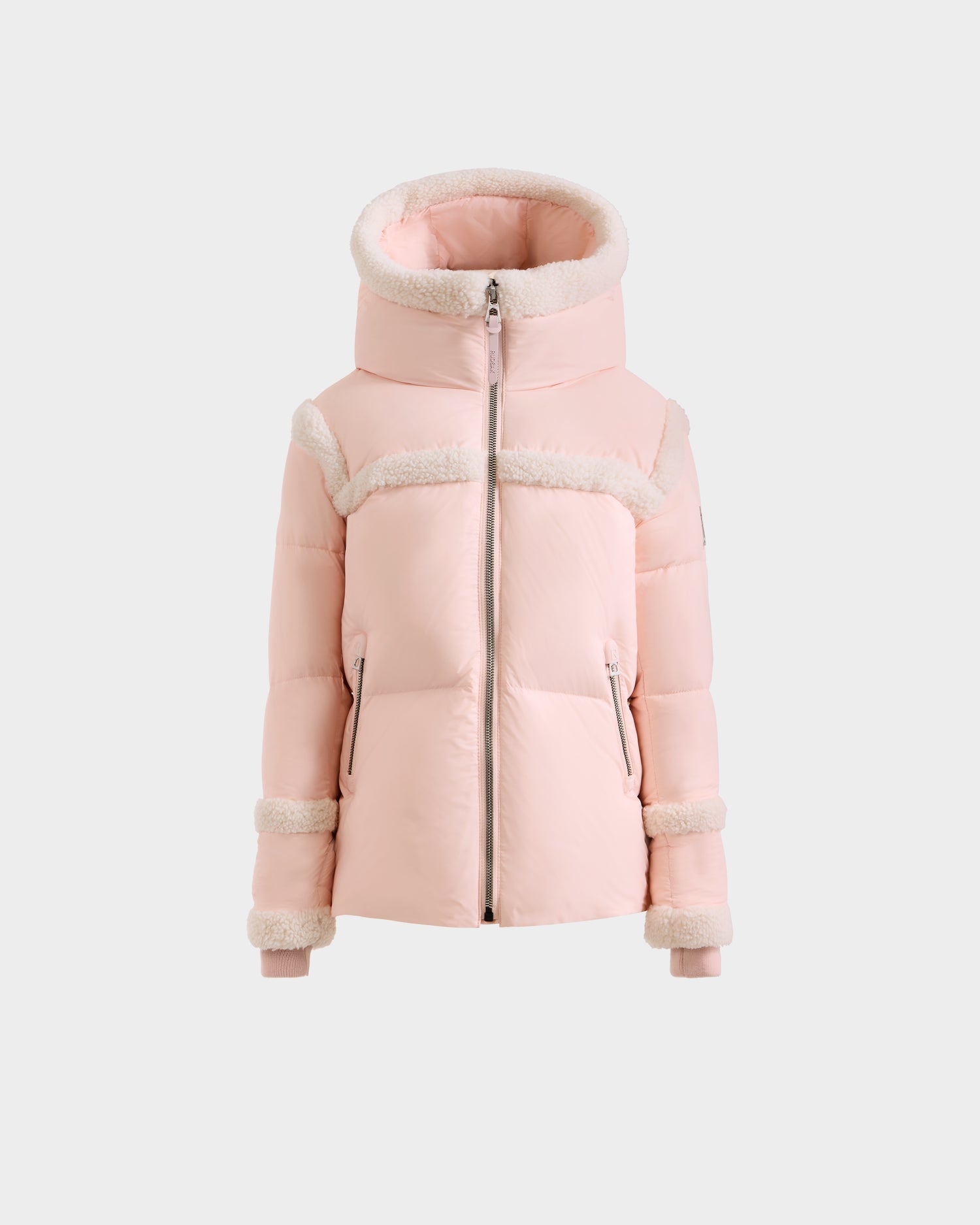 The JULIANA K - K125550 Pastel Pink puffer jacket by Rudsak features a high hood, front zipper, white faux fur trim on shoulders, cuffs and hood, two front zip pockets, and a fitted silhouette.