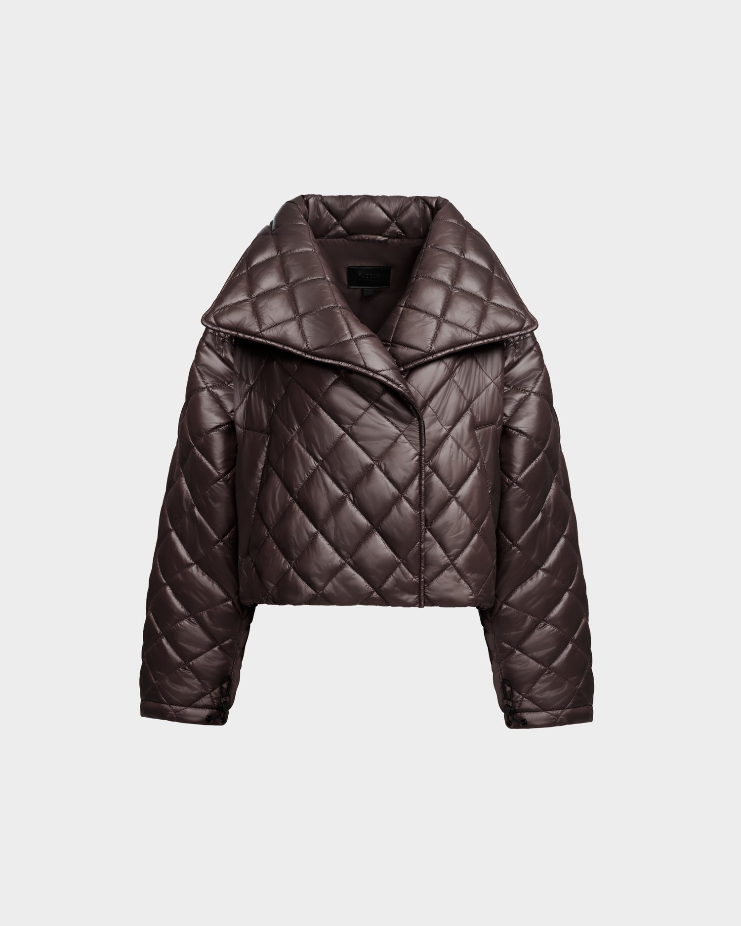 The Rudsak KALEE - 8124005 Espresso is a women's dark brown quilted light jacket with a cropped silhouette, wide collar, and diamond stitching, shown on a plain light gray background.