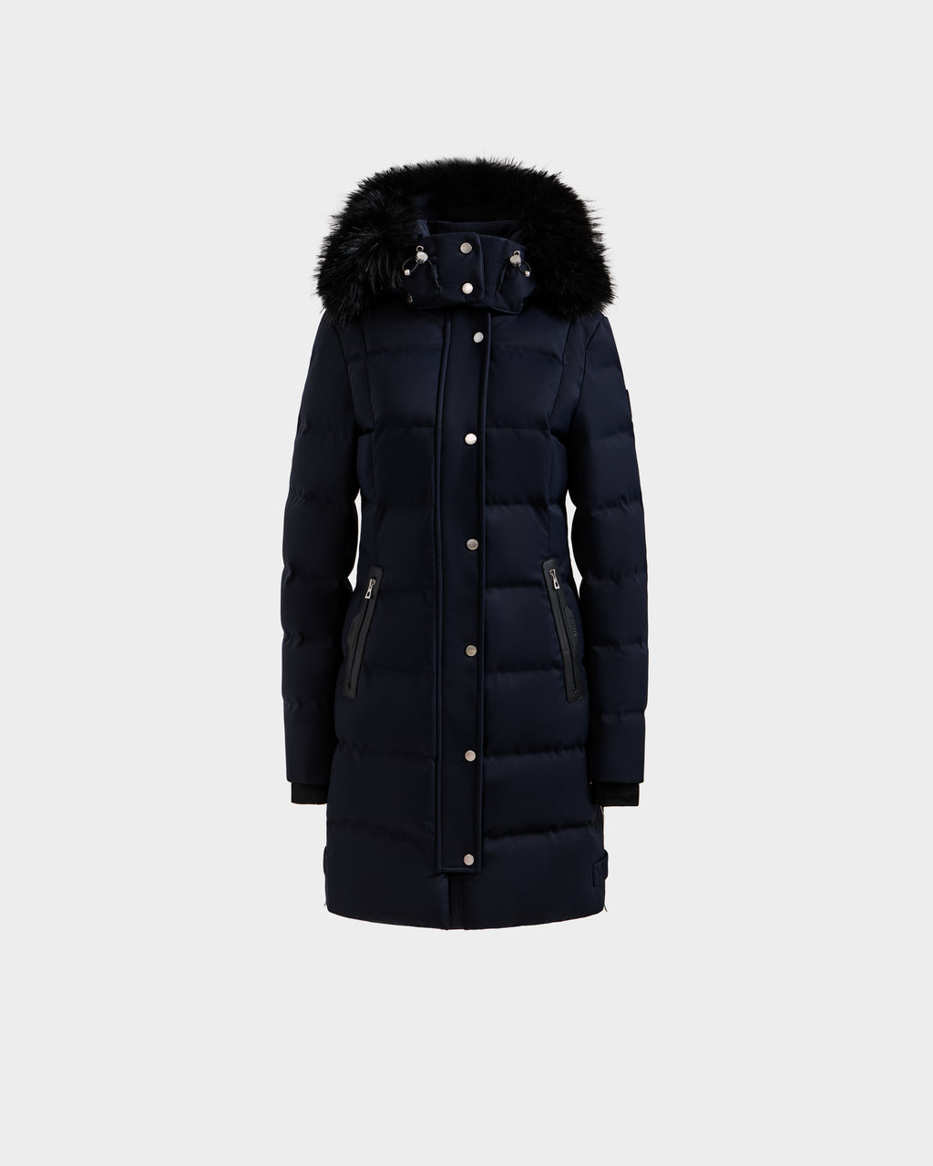 The Rudsak KEHLANI H - 8125643 Navy is a women’s long, dark navy down-filled parka featuring a front zipper with snap buttons, two zippered side pockets, and a black faux fur-trimmed hood, shown against a plain light grey background.