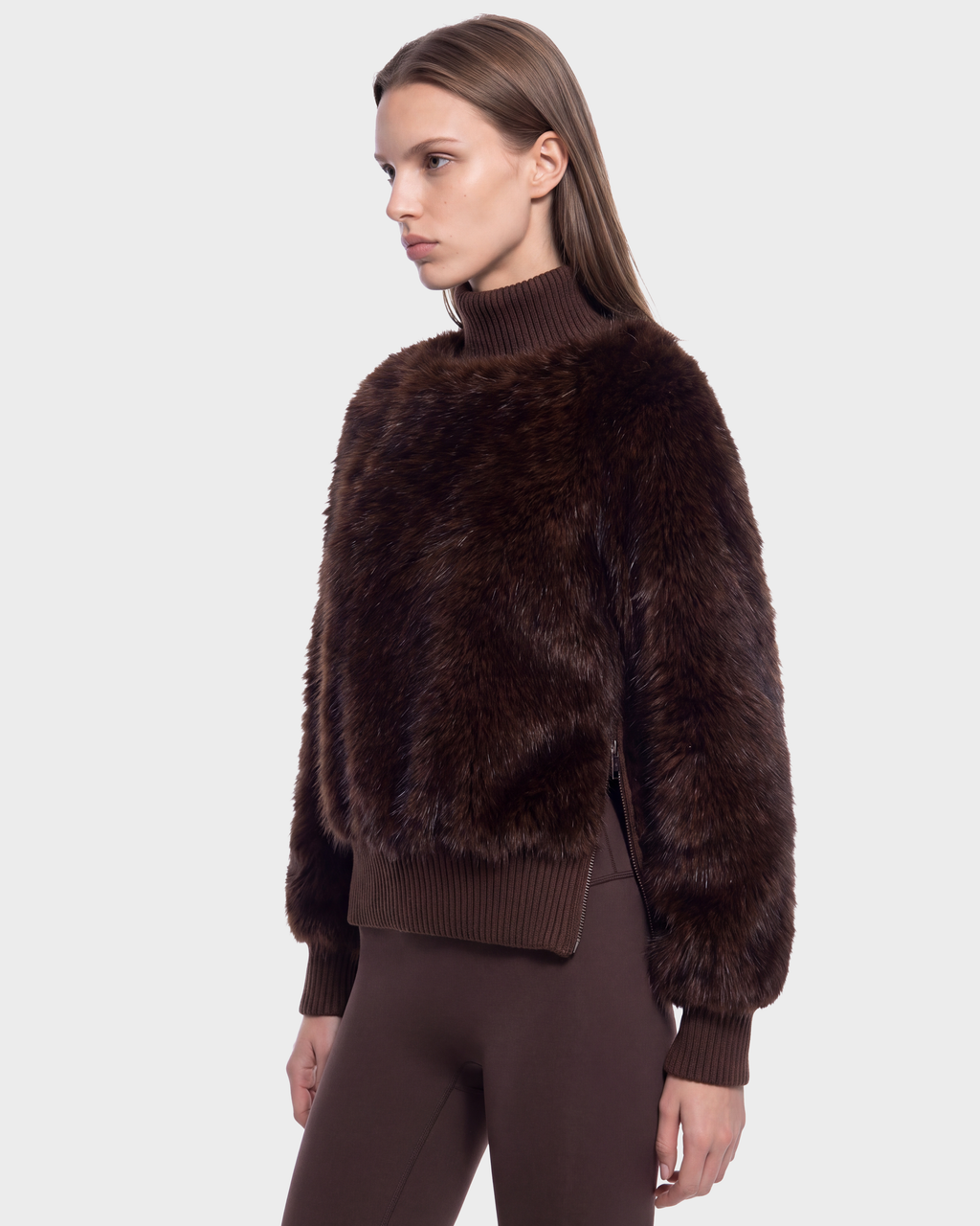 A person wears a Rudsak LAYLA F - 8525630 Mix Expresso dark brown faux fur turtleneck with a cable textured finish, featuring a high ribbed collar and a side zipper.