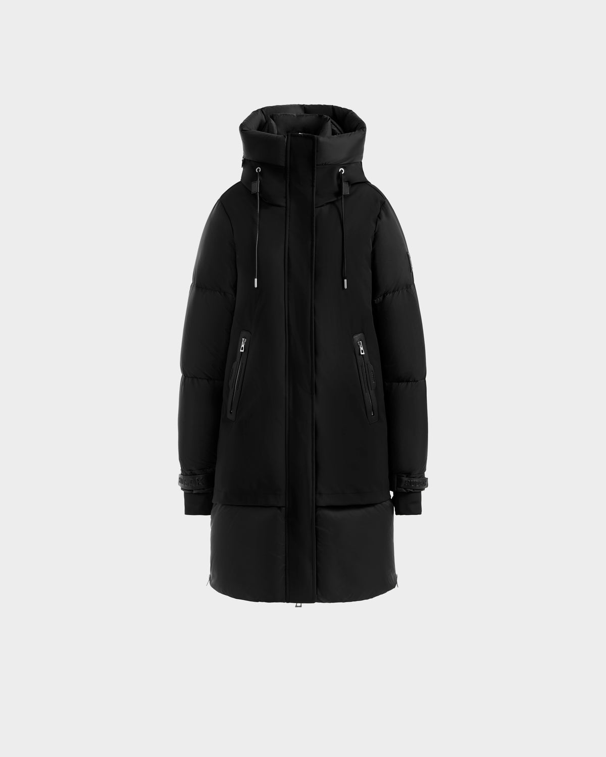 The Rudsak LAYAN - 8124576 Black/Vanilla is a black premium down puffer jacket with a hood, long sleeves, front zip, and two diagonal zippered pockets, shown on a plain light gray background.