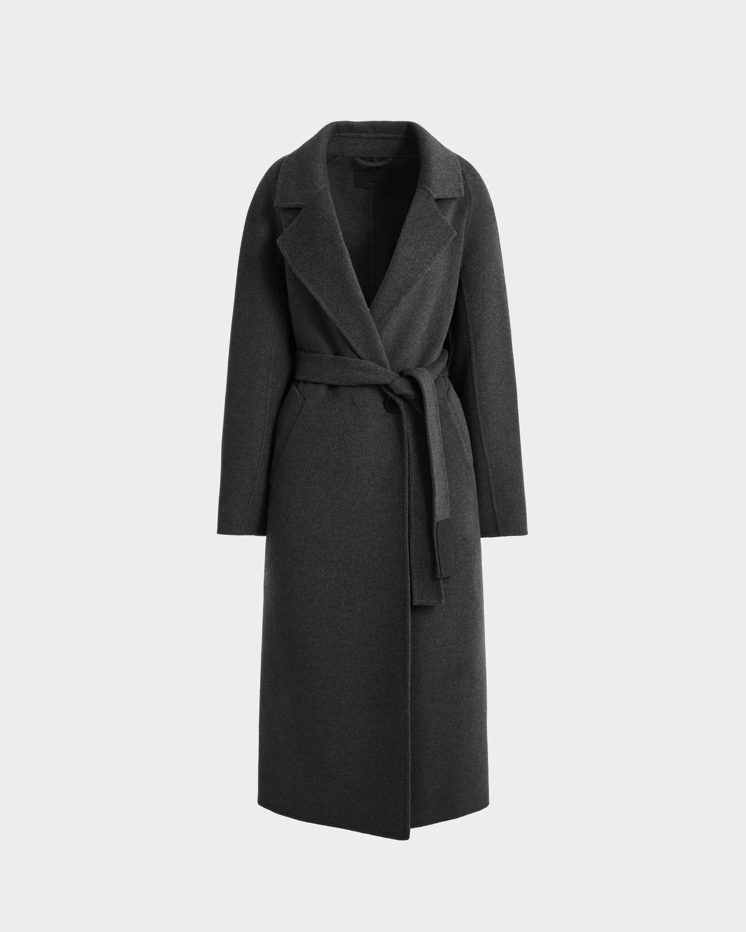 The Rudsak LILIA - 8125634 Heather Charcoal is a womens long wrap coat in dark gray wool, featuring a wide lapel collar and fabric belt at the waist, shown against a plain light gray background.