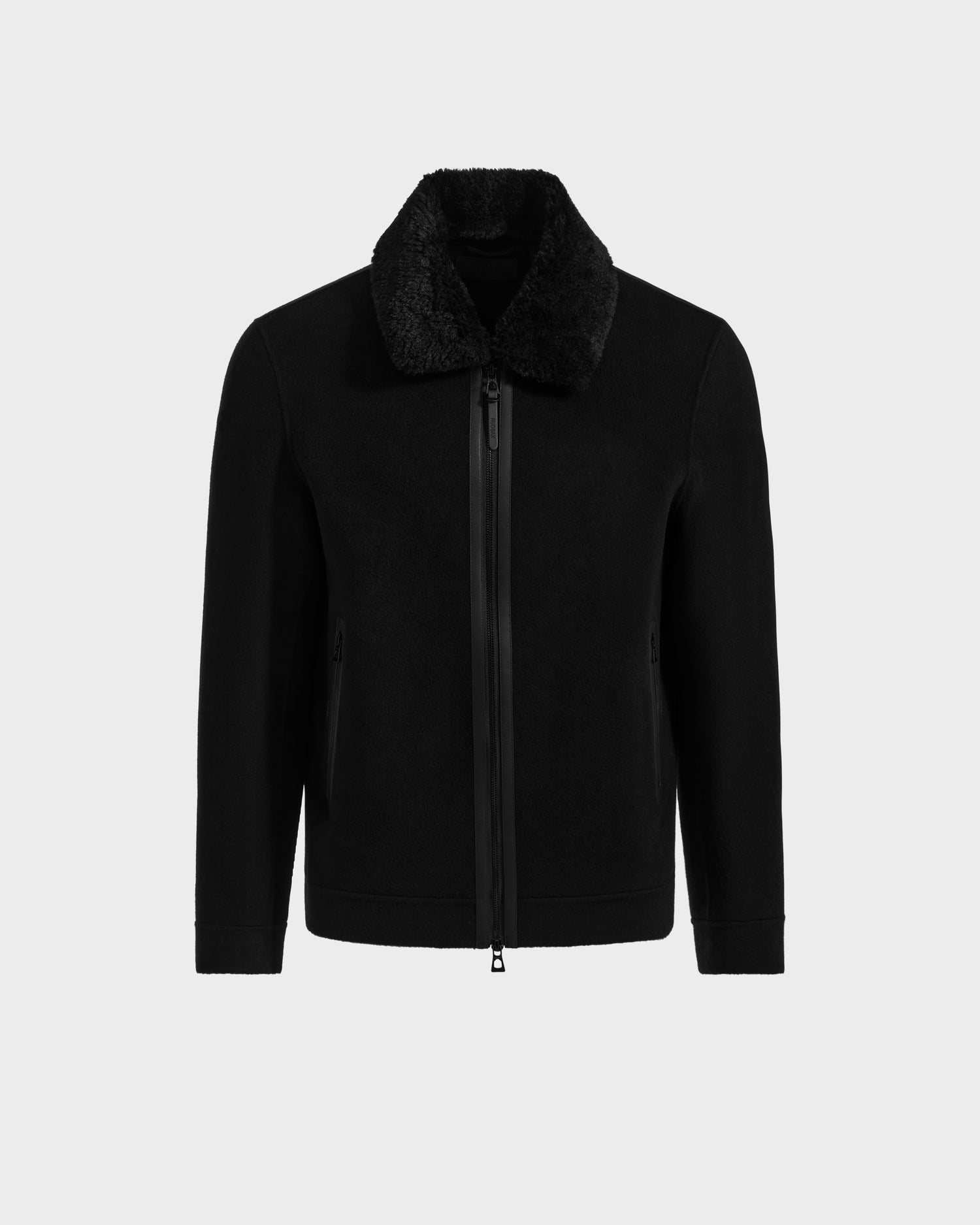 The Rudsak LINCOLN - 6125038 Black jacket features a removable faux fur collar, front zipper closure, and two side pockets, shown against a plain light gray background.