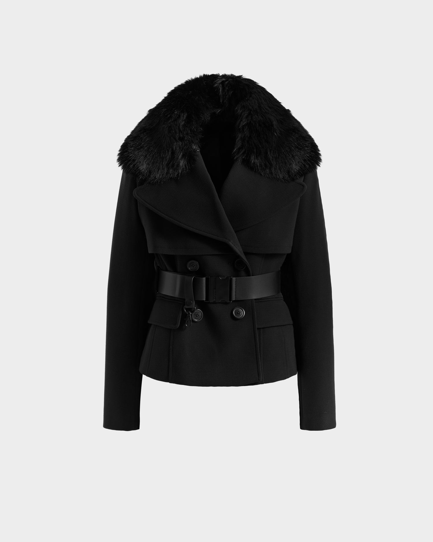 The LINDSAY - 8125538 Black by Rudsak is a black women’s double-breasted transitional coat with a wide faux fur collar, vegan leather belt, and flap pockets, shown on a plain white background.
