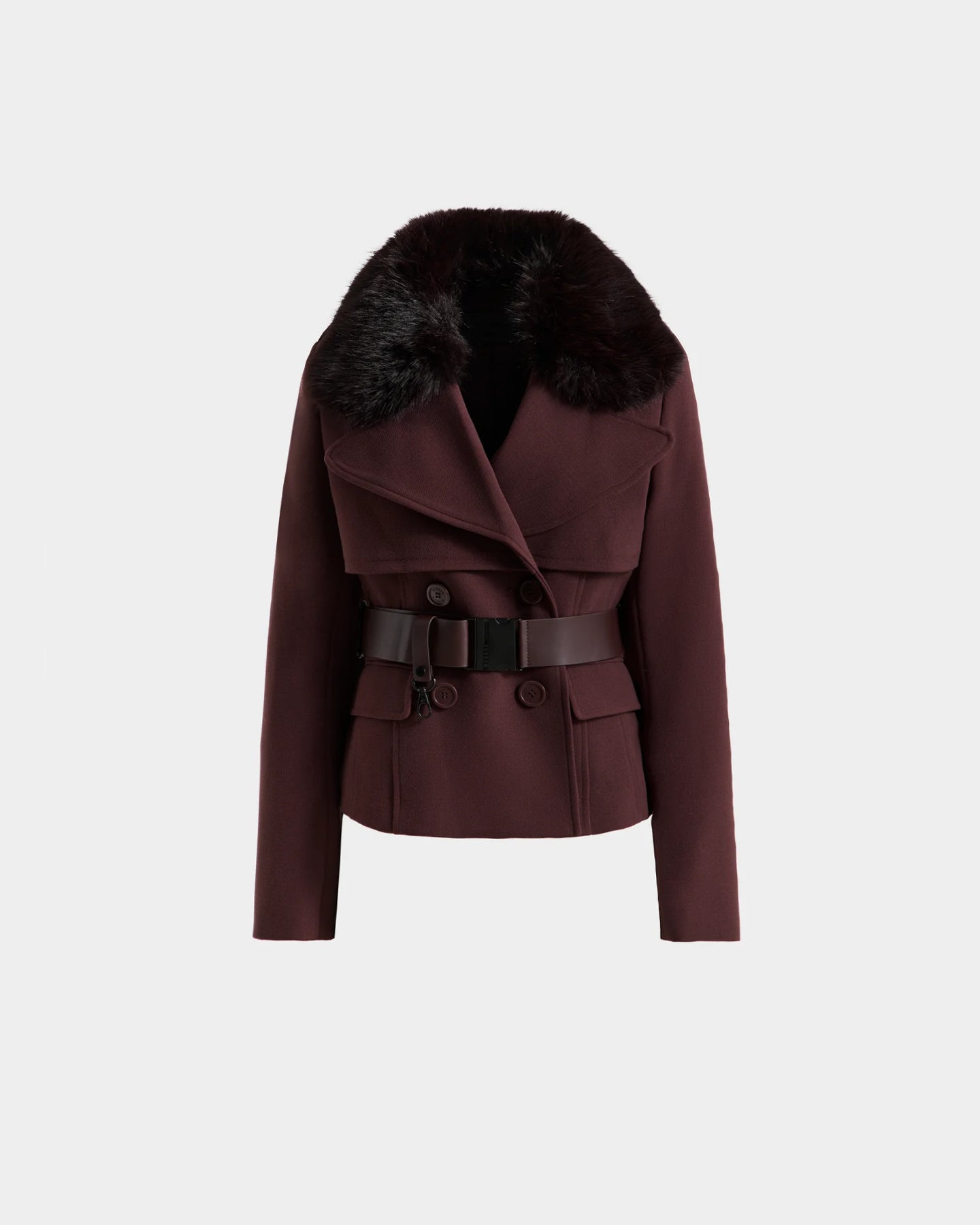 The Rudsak LINDSAY - 8125538 Bordeaux is a women's burgundy double-breasted coat featuring a wide black faux fur collar, vegan leather belt with buckle, and front flap pockets, shown against a plain light background.