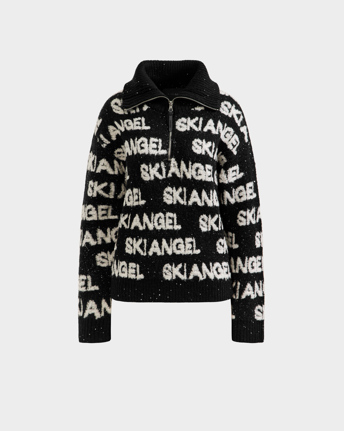 The LYDIA - 8525687 Black sweater by Rudsak is a chic women’s pullover with a high collar and zipper, featuring bold white SKI ANGEL lettering on the front, sleeves, and collar—perfect après-ski knitwear.