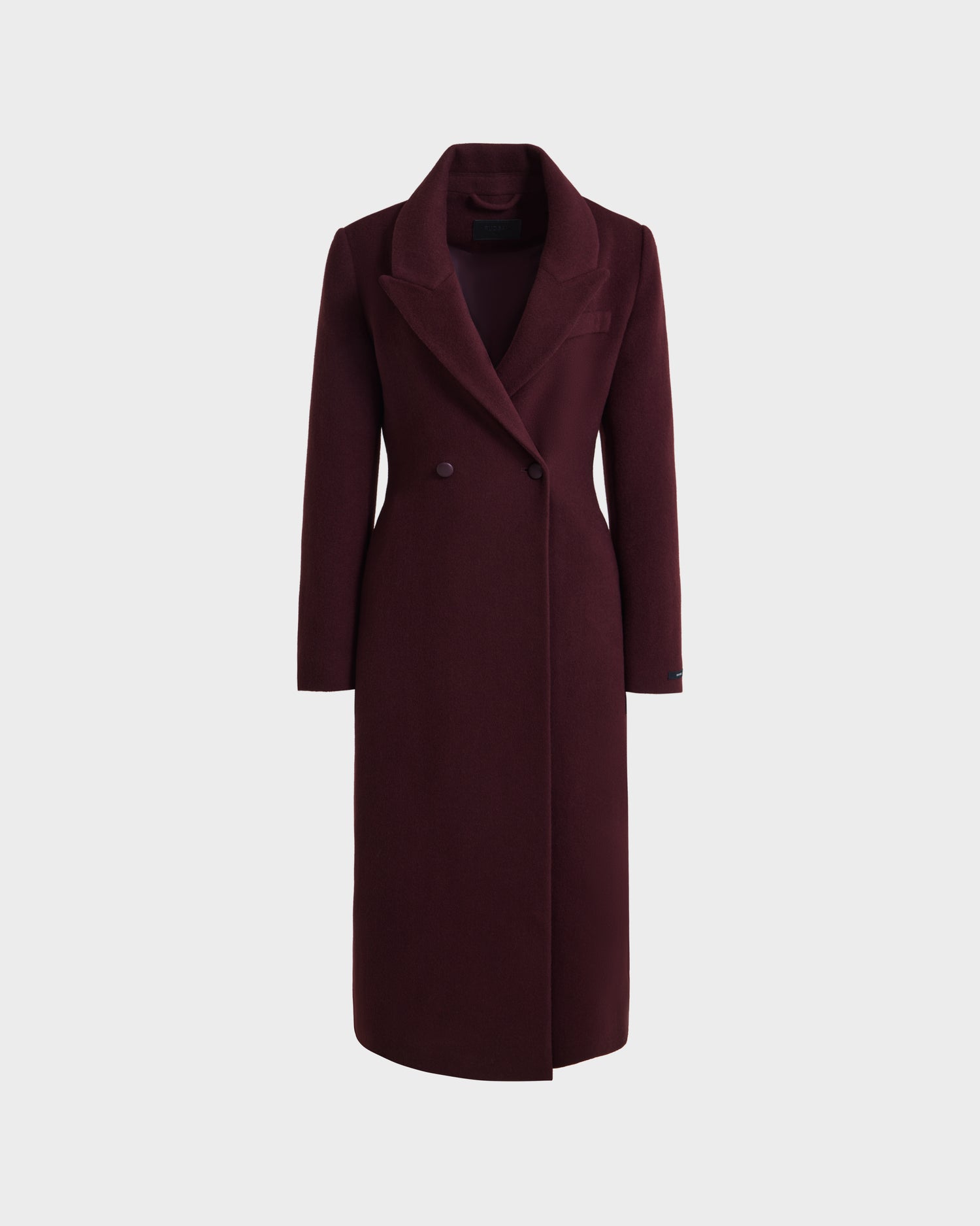 The Rudsak LYNWOOD - 8125539 Bordeaux is a womens long tailored coat in deep burgundy premium wool with a notched lapel collar, two front buttons, and a sleek fit, shown against a plain white background.
