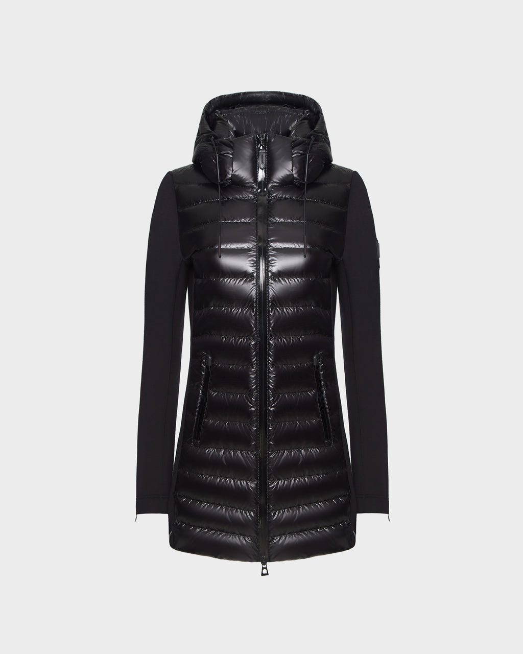 The Rudsak MERINA - 8121006 BLACK is a women’s long-sleeve hooded jacket with a shiny quilted front, solid black sleeves, side pockets, and front zipper, displayed on a light gray background.