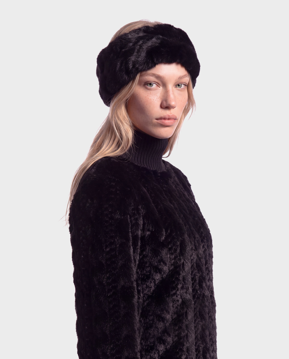 A woman wearing a black faux fur headband and a black textured MILA - 8426518 Black jacket.