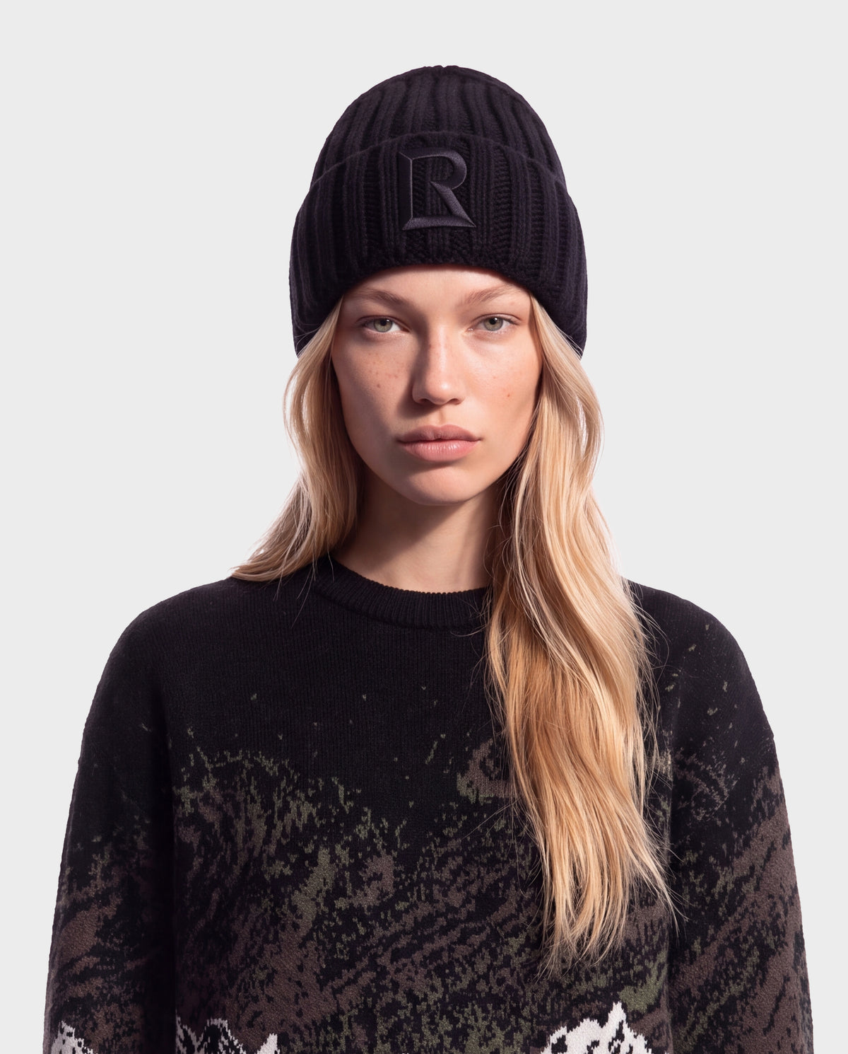 Black Rudsak MISSA - 8426512 Black ribbed knit beanie with a centered letter R logo on the front cuff.