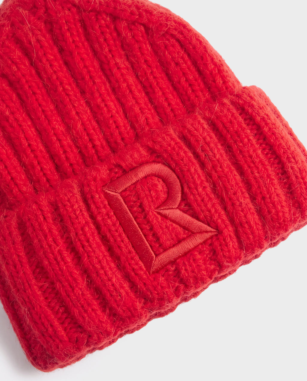 Bright red ribbed knit MISSA - 8426512 Flame Red beanie with a tonal embroidered letter R on the cuff.