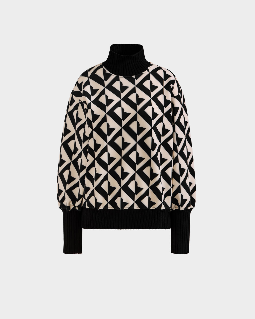 The Rudsak MAGGIE - 8525645 Vanilla Monogram is a long-sleeve, high-neck alpine sweater with black ribbed cuffs and hem, showcasing a bold black and beige geometric heart pattern on the body and sleeves.