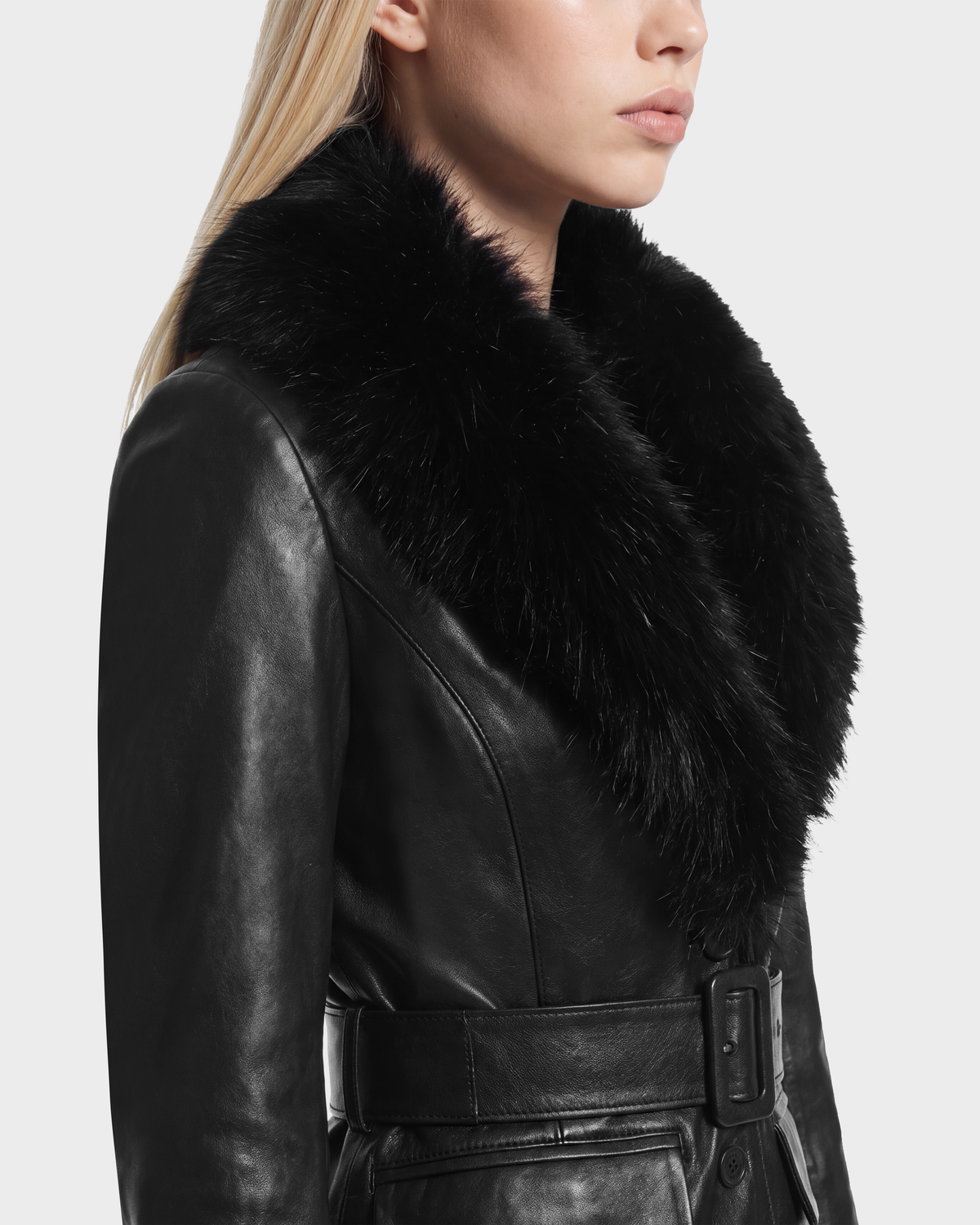 Profile view of the MARILLA - 8126972 Black leather coat, featuring a large fur collar and a belted waist.