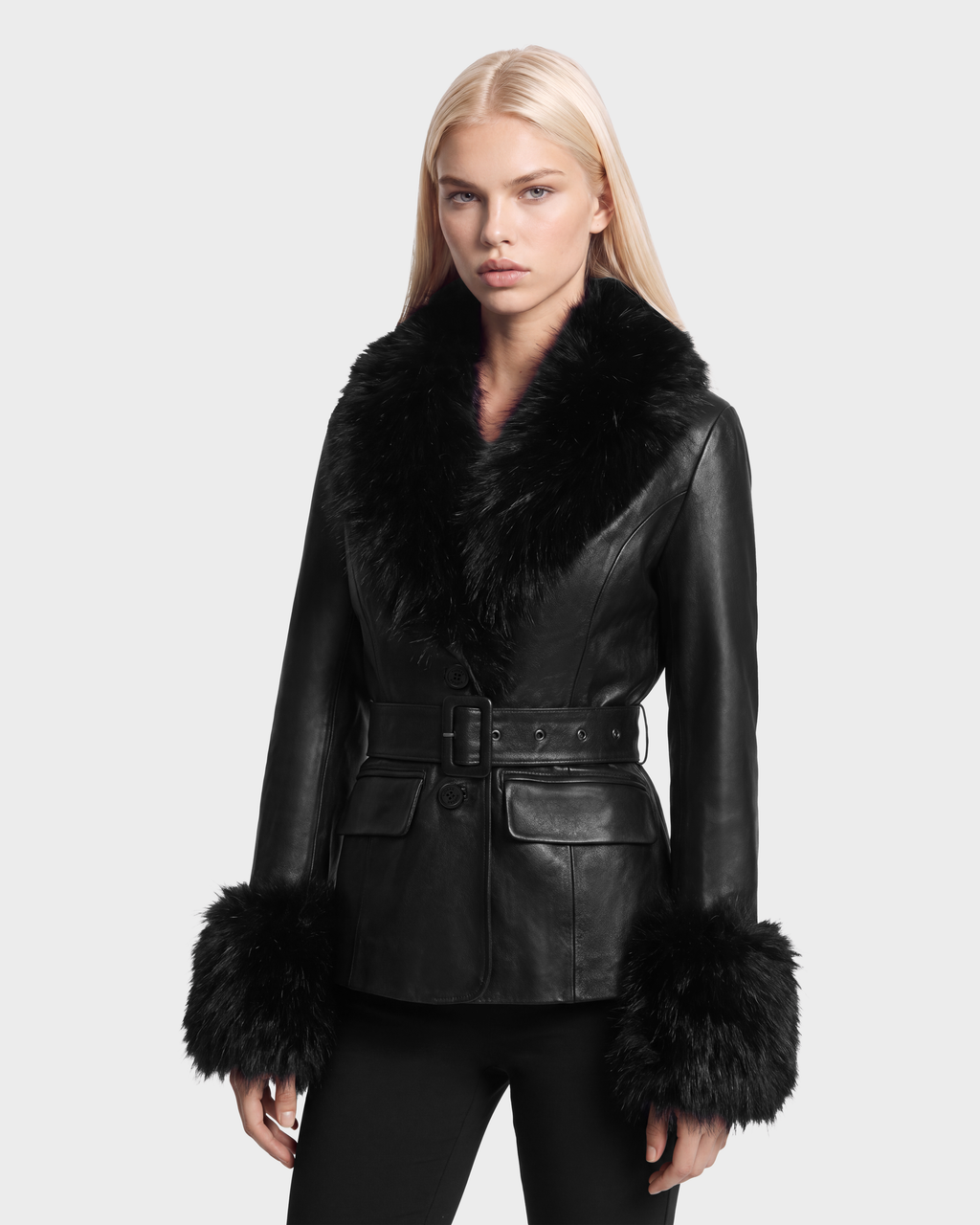 A woman wears a MARILLA - 8126972 Black leather jacket featuring a belted waist, fur collar, and fur-trimmed cuffs.
