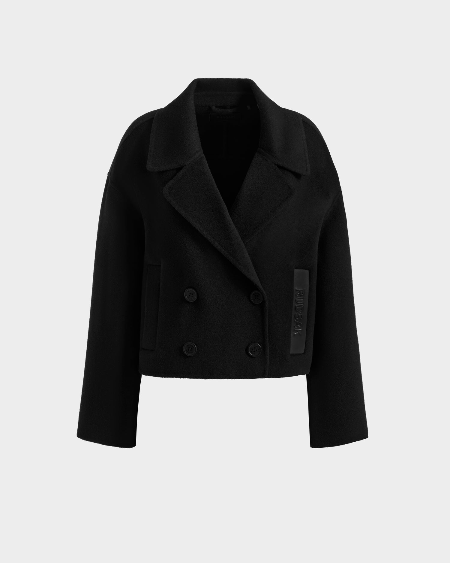 The Rudsak MARTINEZ - 8125580 Black is a women's short, double-breasted wool-blend coat with a wide collar, long sleeves, cropped fit, and two rows of buttons, shown against a plain white background.