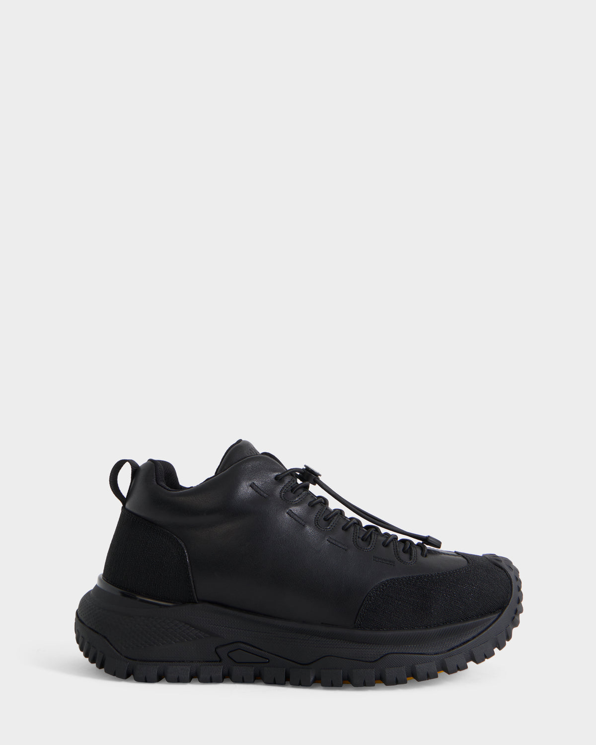 The Rudsak MAX - 6226502 Black is a men’s sneaker featuring a black low-top design with a textured sole, lace-up front, and mixed material upper, shown in profile against a plain white background for a utility-inspired look.
